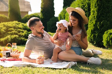 Photo of Happy family having picnic in garden on sunny day