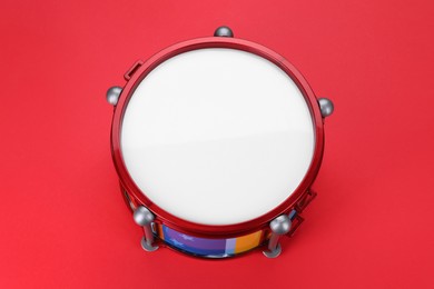 Drum on red background, above view. Percussion musical instrument