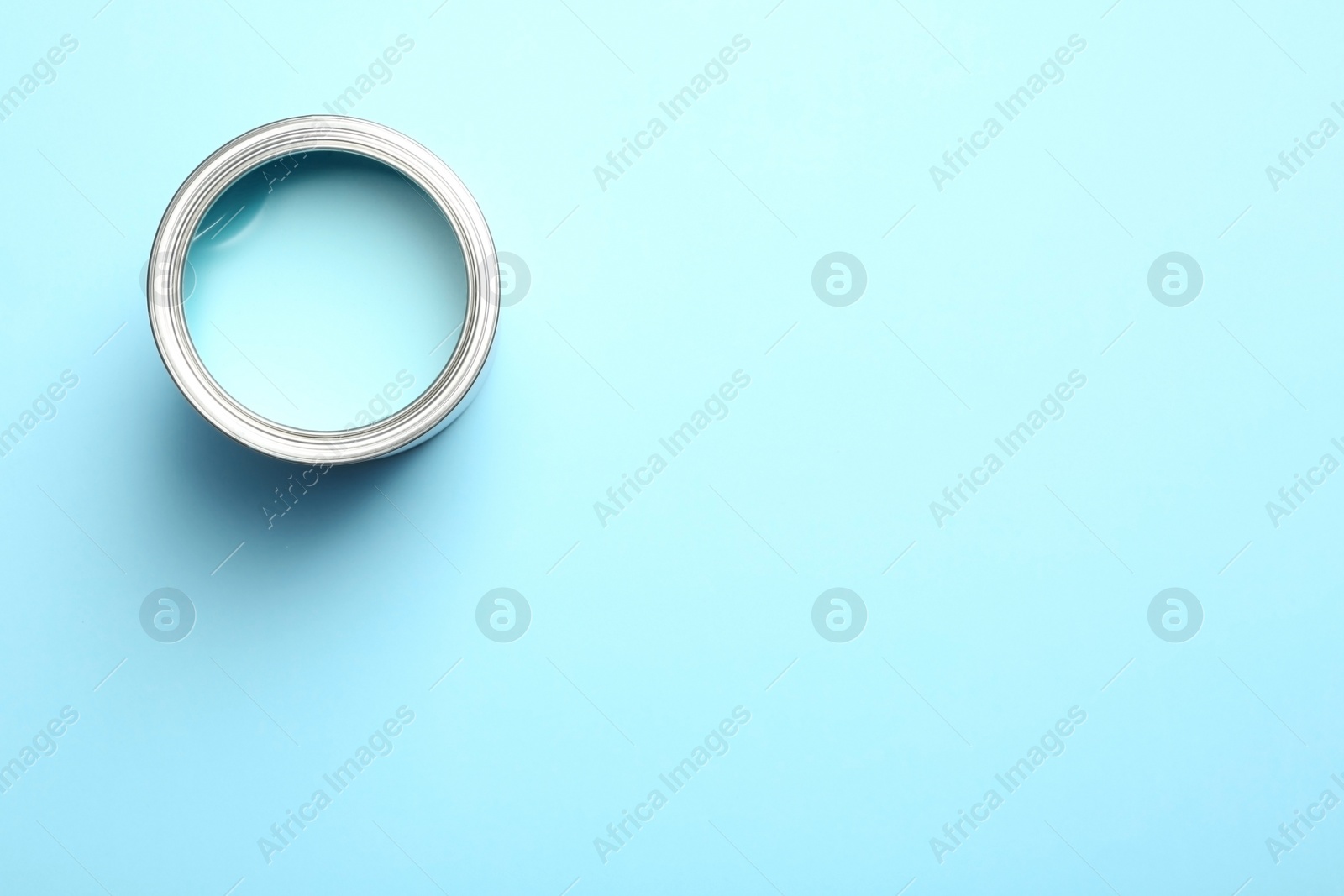 Photo of Paint can on color background, top view. Space for text