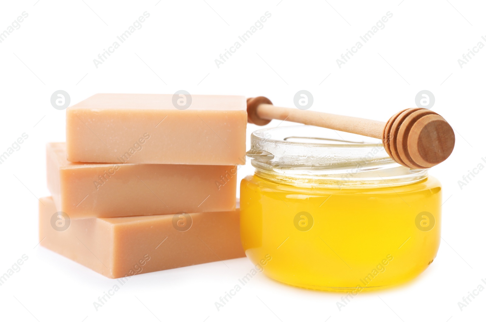 Photo of Handmade soap bars and jar of honey on white background