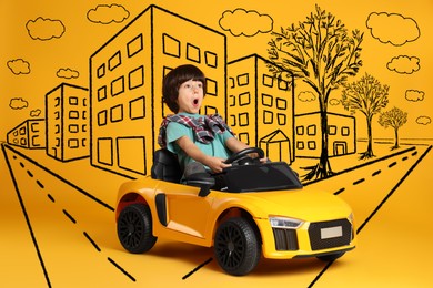 Image of Cute little boy driving toy car and drawing of city on yellow background