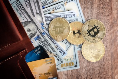 Image of Bitcoins, dollar banknotes and wallet with credit cards on wooden background, flat lay