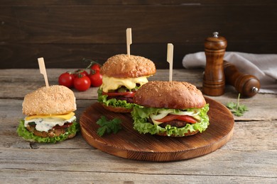 Photo of Delicious vegetarian burgers served on wooden table