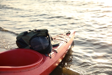 Photo of Red kayak with bags on river. Summer camp activity