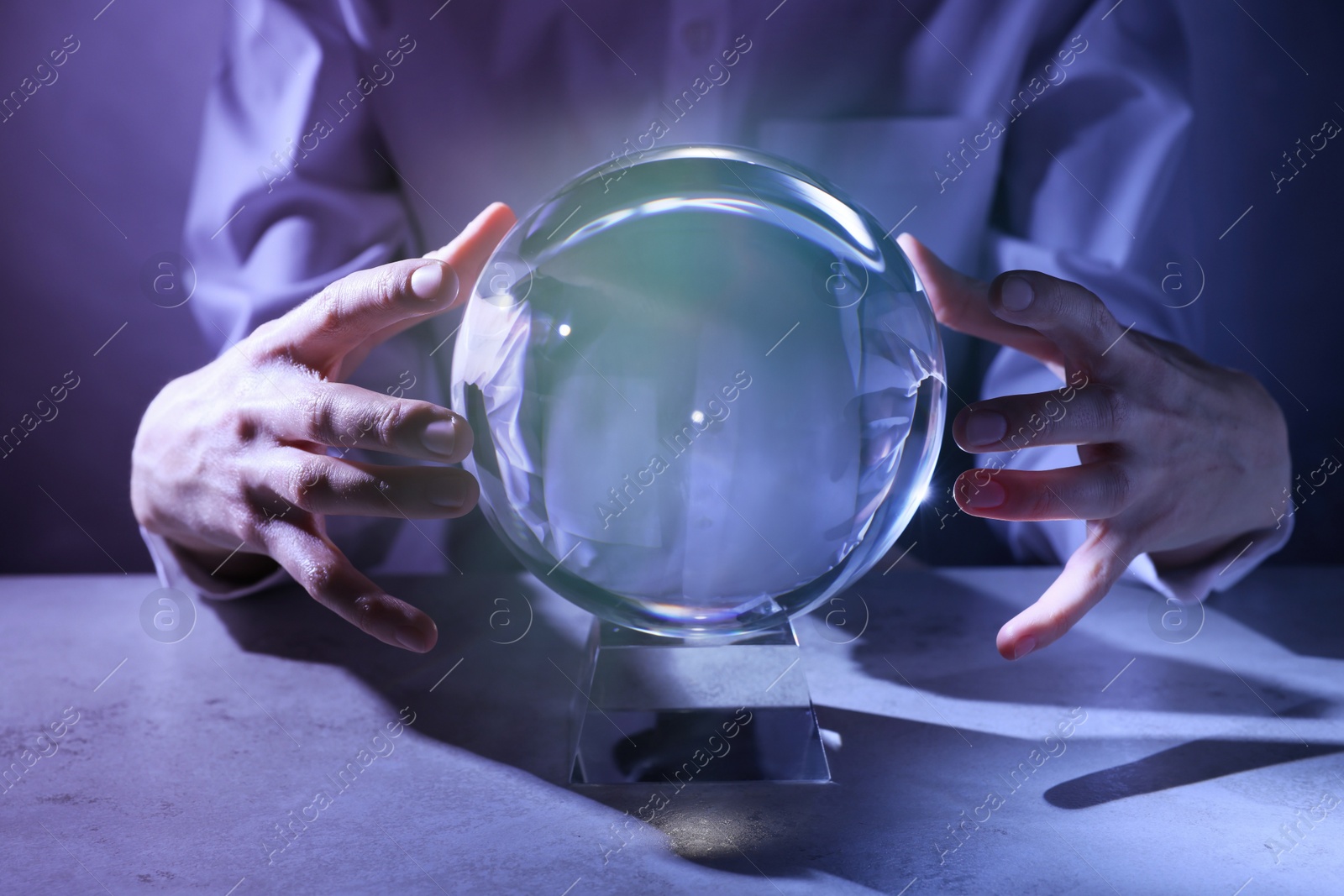 Photo of Businesswoman using crystal ball to predict future at table, closeup