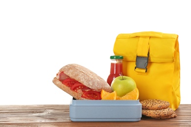 Lunch box with appetizing food and bag on table against white background