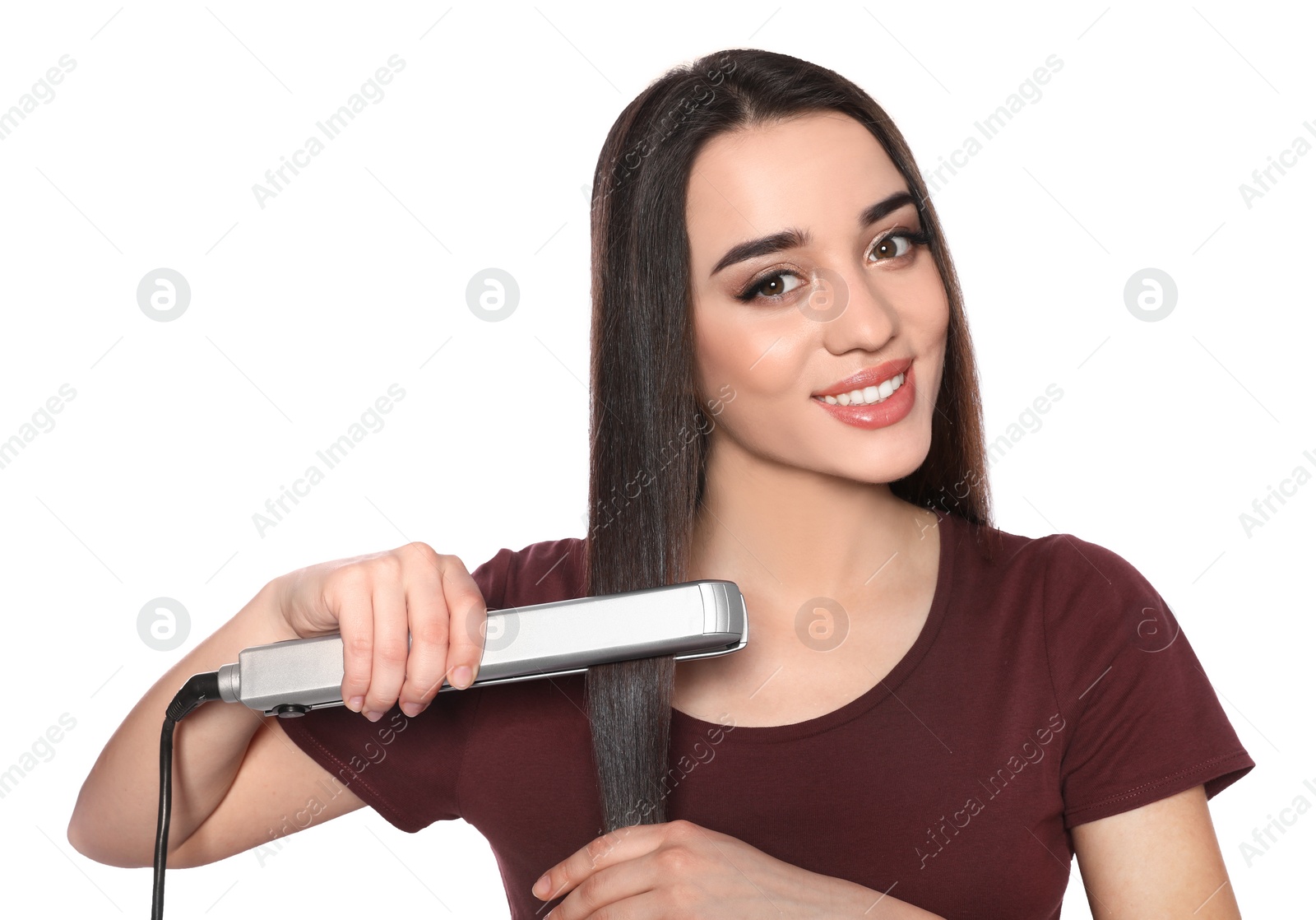 Photo of Happy woman using hair iron on white background