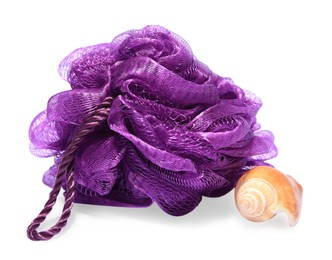 Photo of New purple shower puff with seashell on white background. Personal hygiene