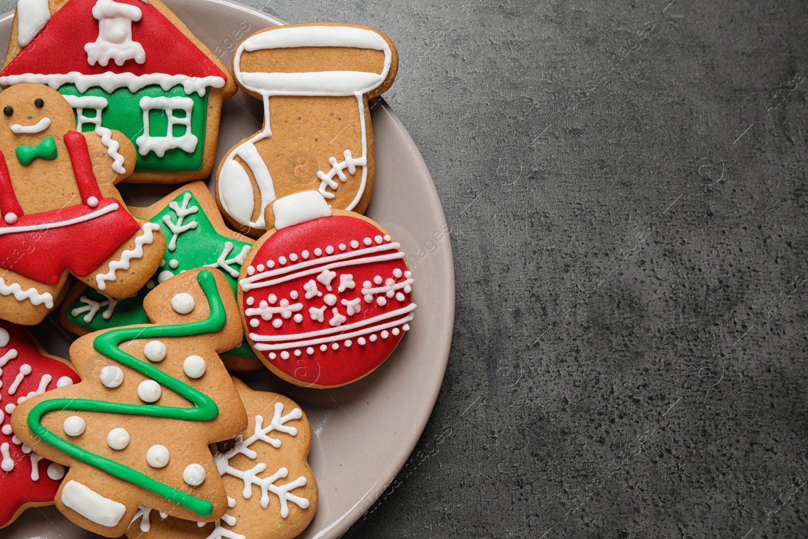 Photo of Tasty homemade Christmas cookies on grey table, top view. Space for text