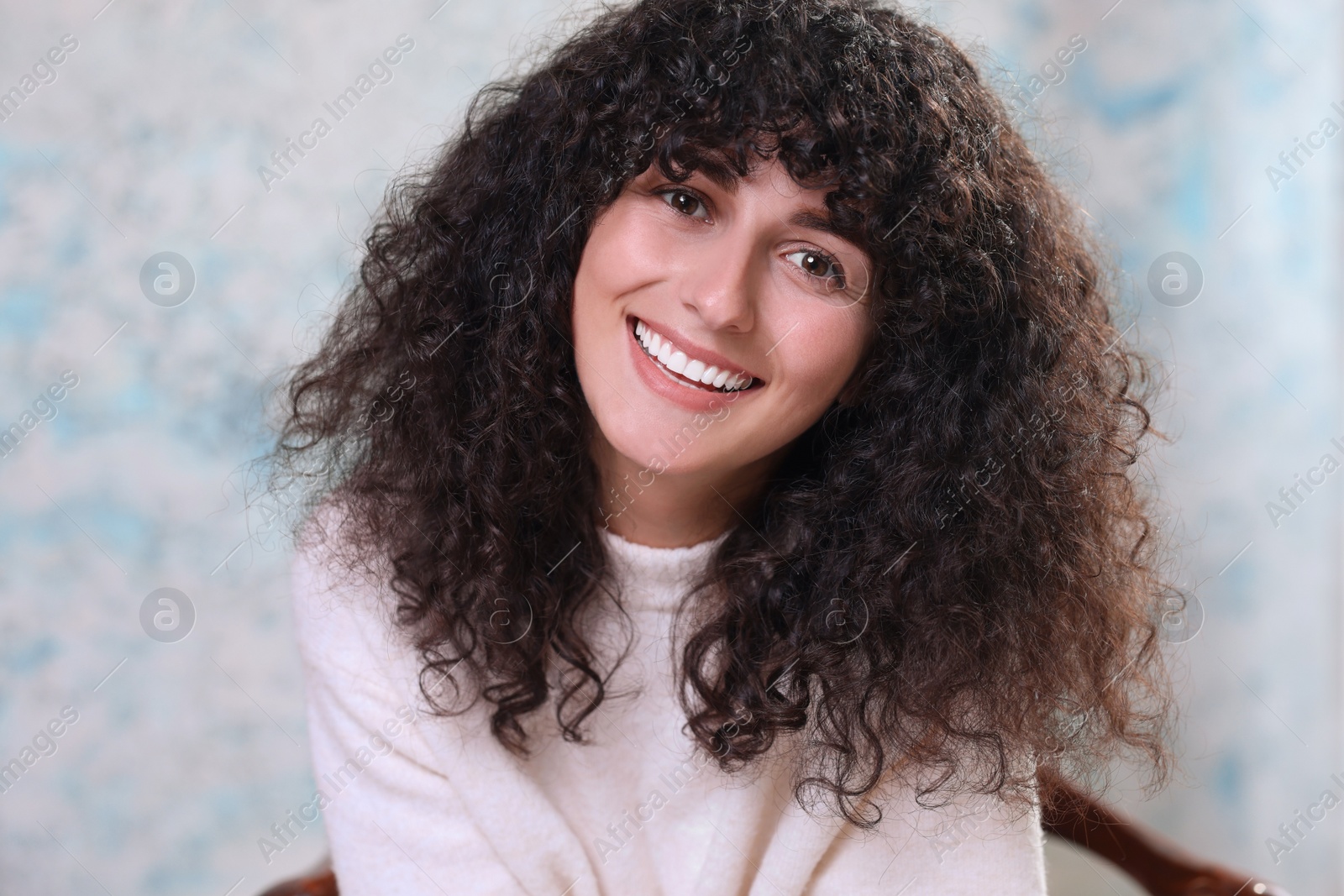 Photo of Portrait of happy young woman in stylish sweater on color background