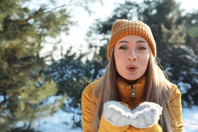 Woman enjoying winter day in forest, space for text