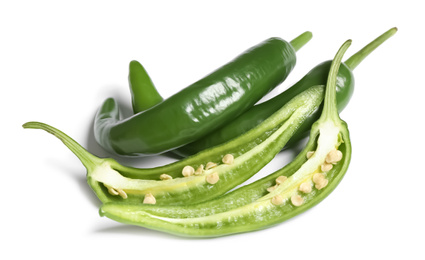 Photo of Cut and whole green hot chili peppers on white background