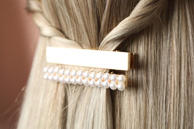 Photo of Woman with beautiful gold hair clips, closeup