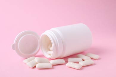 Jar with chewing gums on pink background, closeup