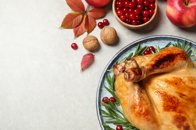 Traditional Thanksgiving day feast with delicious cooked turkey and autumn decor on grey table, flat lay. Space for text