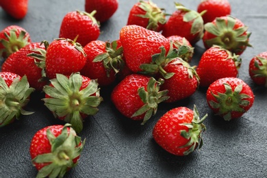 Ripe red strawberries on black background, closeup