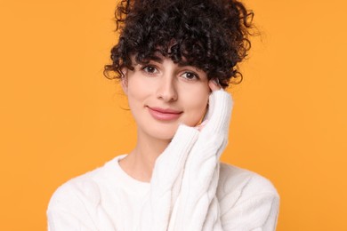 Photo of Young woman in stylish white sweater on yellow background