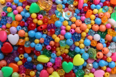 Photo of Many different bright beads as background, top view