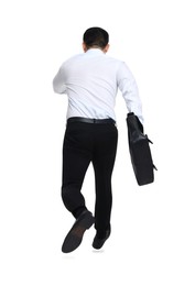 Photo of Businessman with briefcase running on white background, back view
