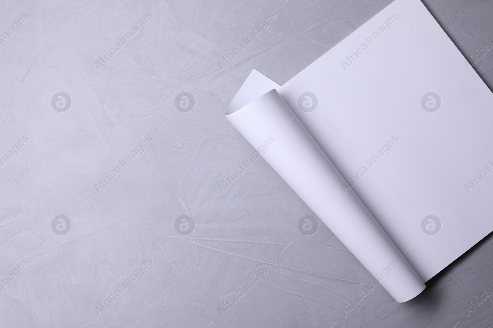 Photo of Blank paper sheet on grey textured background, top view. Mockup for design