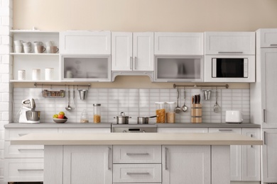 Photo of Modern kitchen interior with houseware and new furniture