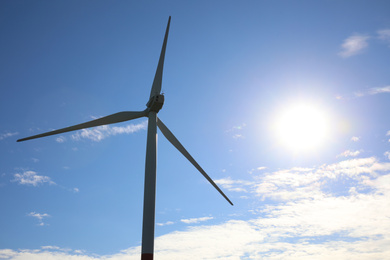 Photo of Wind turbine against beautiful blue sky. Alternative energy source