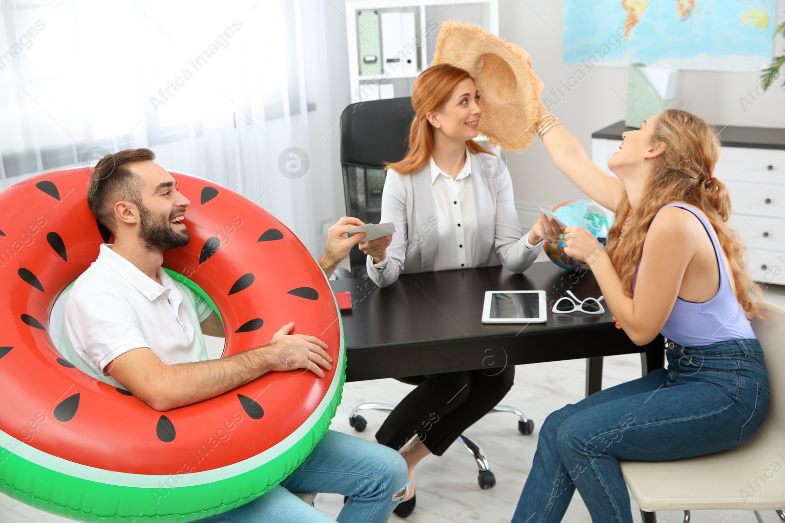 Photo of Beautiful young couple visiting travel agency office