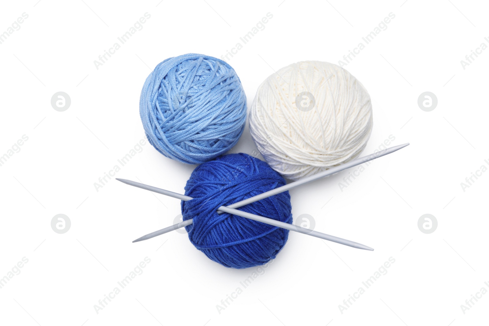 Photo of Soft woolen yarns with knitting needles on white background, top view