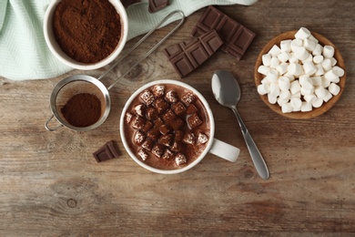 Photo of Composition with delicious hot cocoa drink and marshmallows on wooden background, flat lay