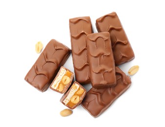 Photo of Chocolate bars with caramel, nuts and nougat isolated on white, top view