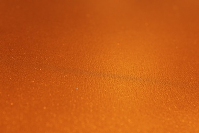 Photo of Golden textured surface as background, closeup view