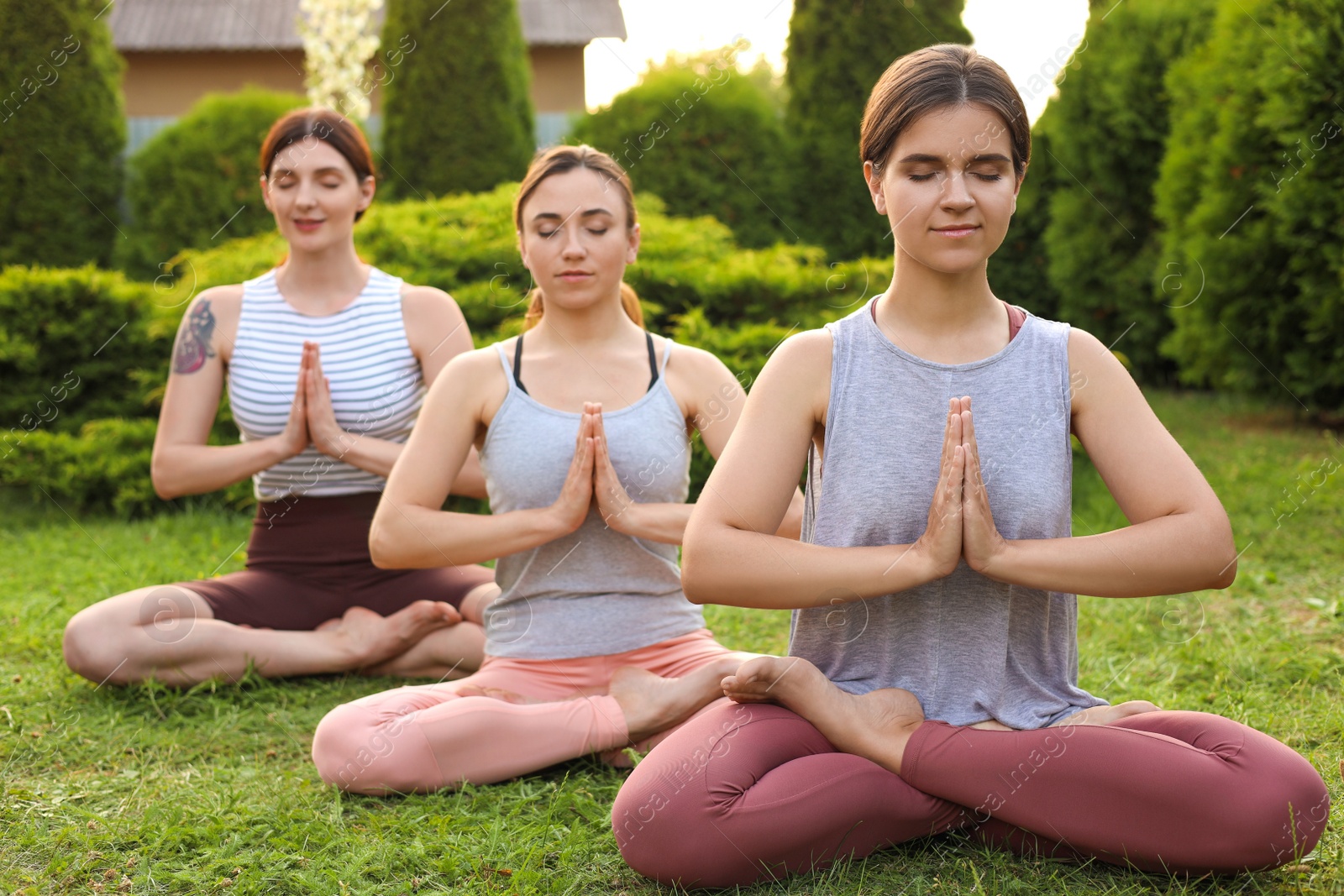 Photo of Group of young women practicing yoga outdoors