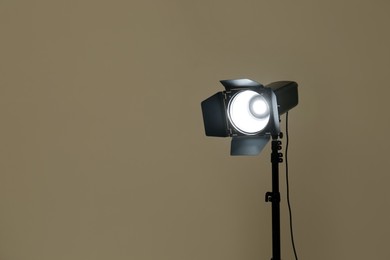 Photo of Modern spotlight against beige background, space for text