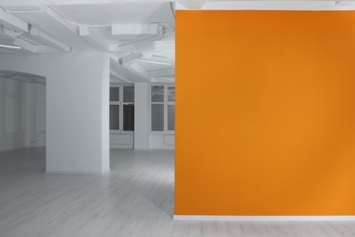 Photo of Empty renovated room with white and orange walls