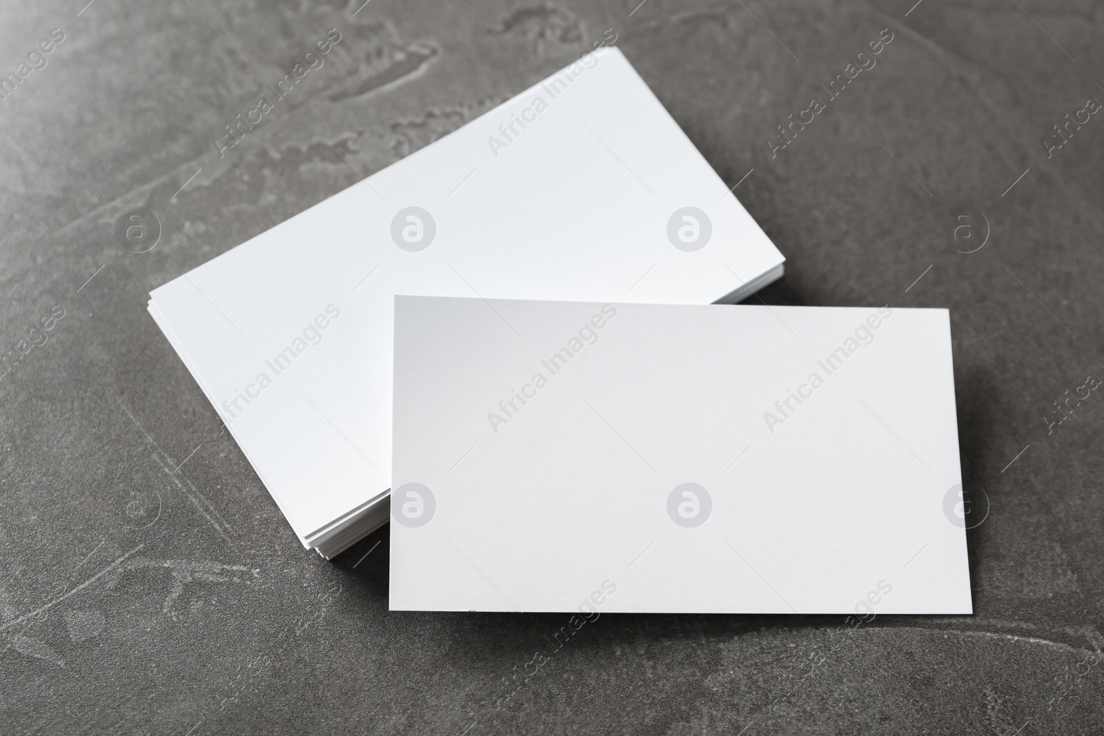 Photo of Blank business cards on grey table, above view. Mockup for design