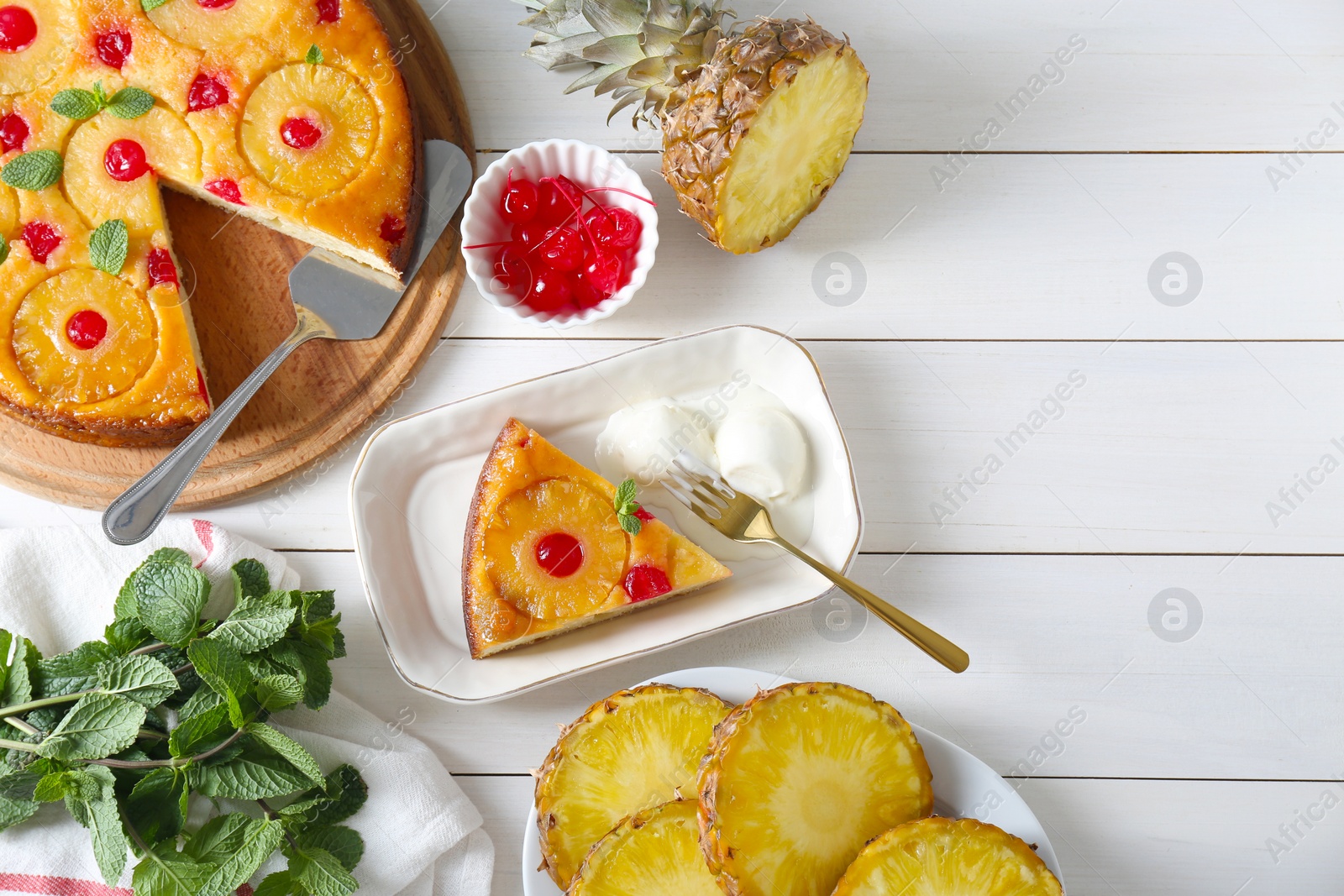 Photo of Delicious cut pineapple pie served with ice cream on white wooden table, flat lay. Space for text