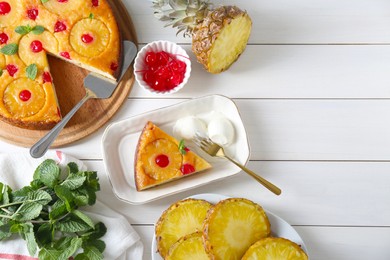 Delicious cut pineapple pie served with ice cream on white wooden table, flat lay. Space for text