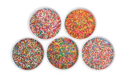 Photo of Colorful sprinkles in bowls on white background, top view. Confectionery decor