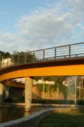 Blurred view of modern bridge in park