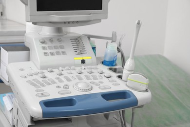 Photo of Ultrasound machine near white wall in hospital, closeup