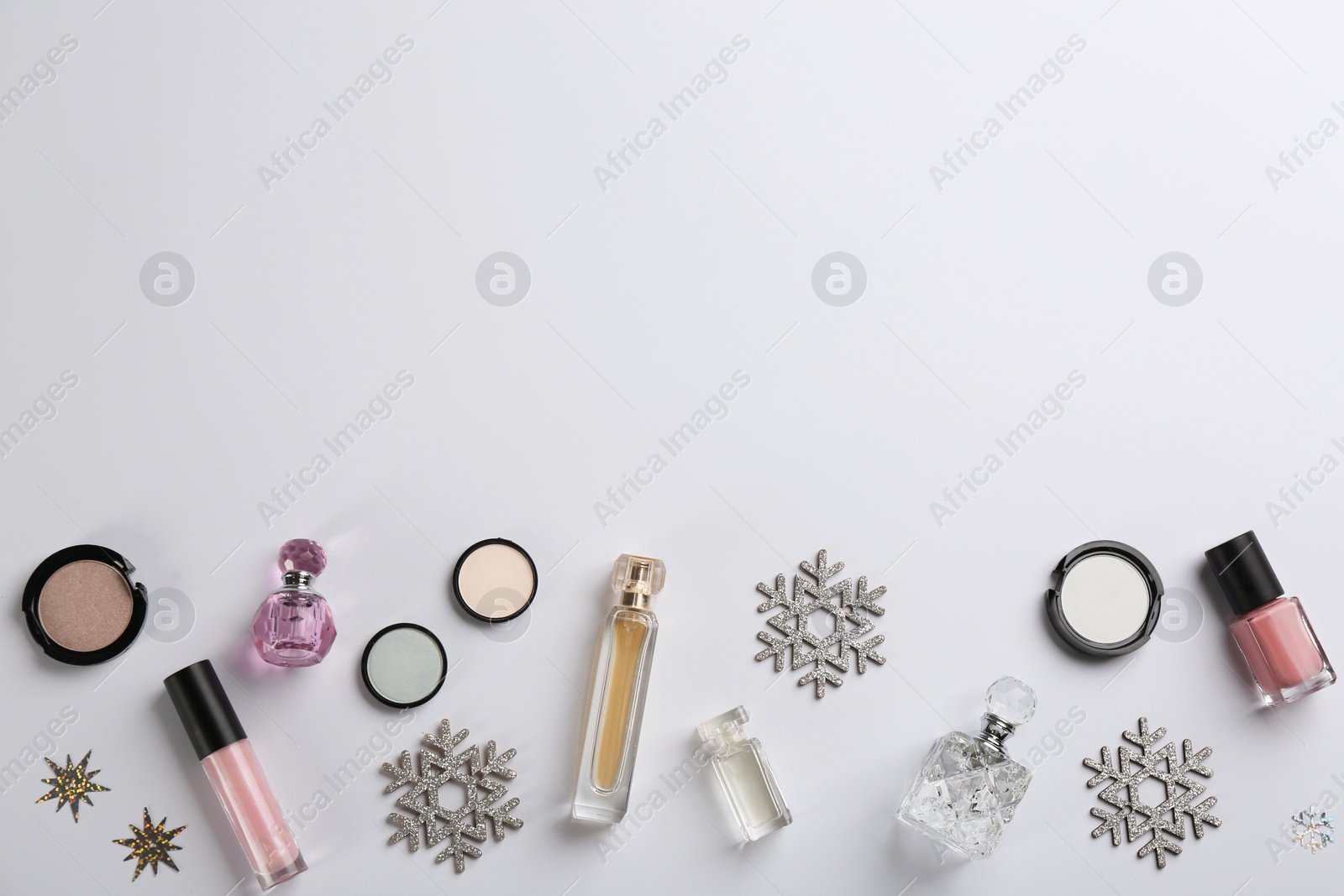 Photo of Flat lay composition with decorative cosmetic products on light background. Winter care. Space for text