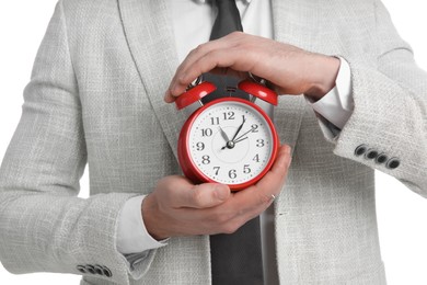 Photo of Businessman holding alarm clock, closeup view. Time management