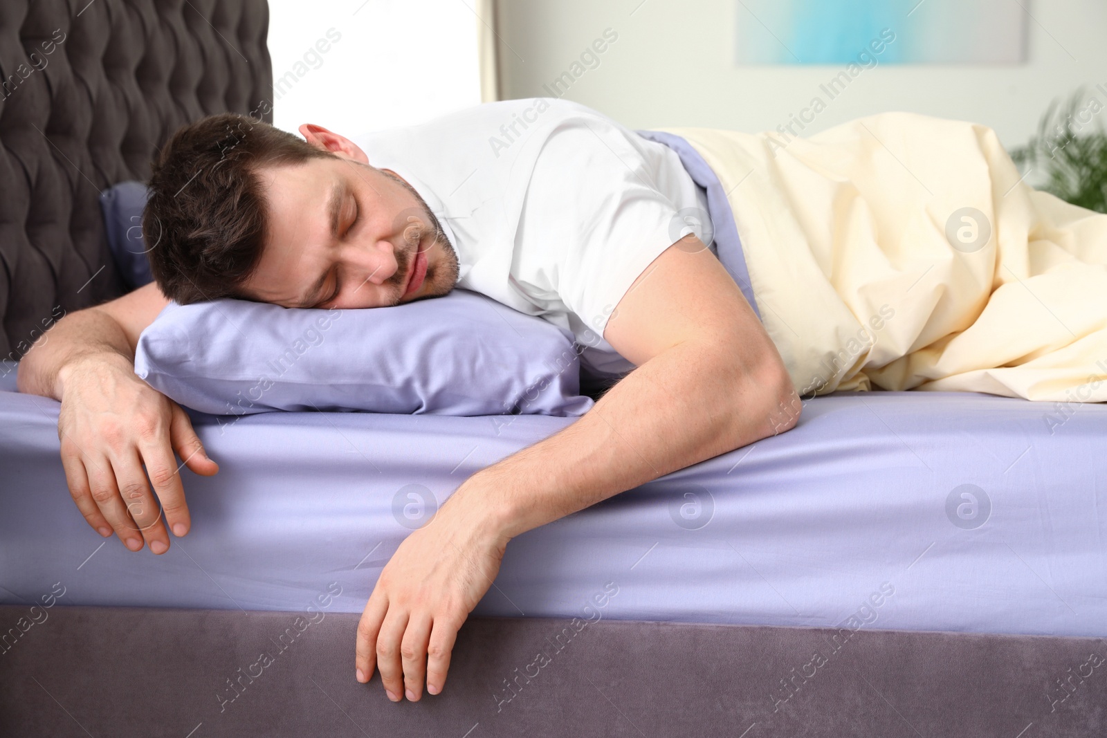 Photo of Handsome man sleeping on pillow at home. Bedtime