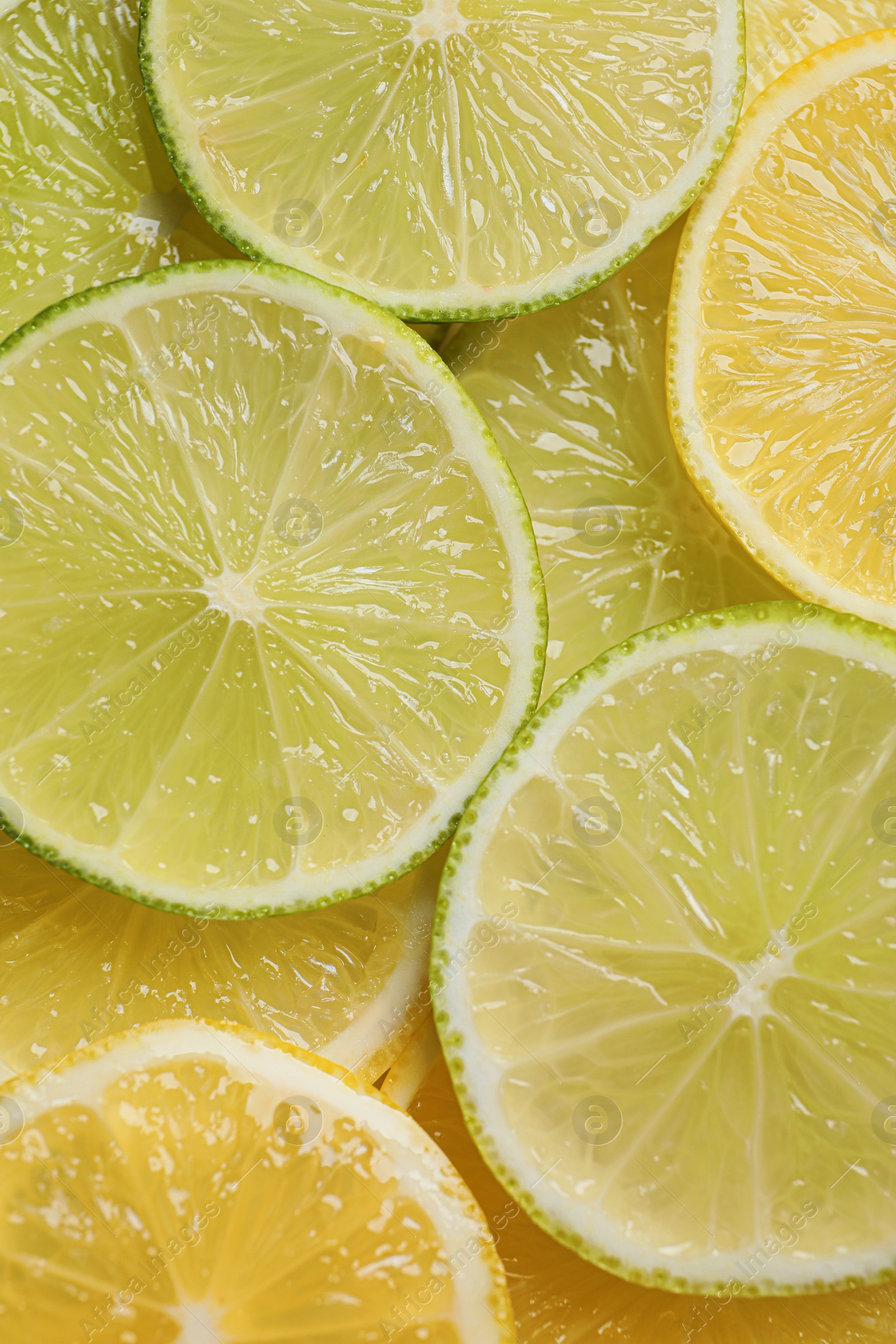 Photo of Slices of lemon and lime as background, top view