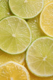 Photo of Slices of lemon and lime as background, top view