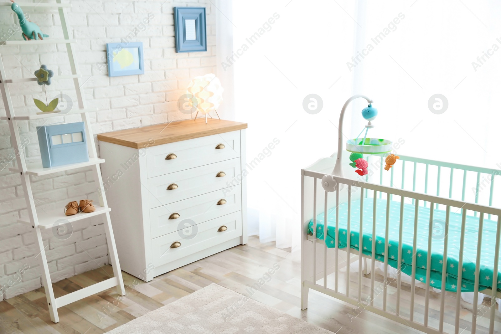 Photo of Modern interior of light cozy baby room with crib