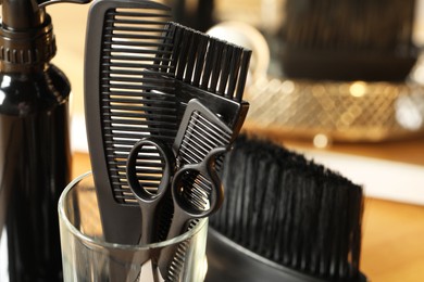Photo of Set of hairdresser tools in salon, closeup