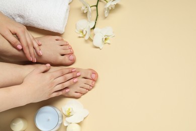 Closeup of woman with neat toenails after pedicure procedure on beige background, top view. Space for text