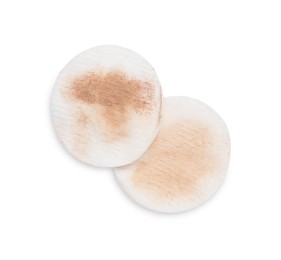 Photo of Dirty cotton pads after removing makeup on white background, flat lay