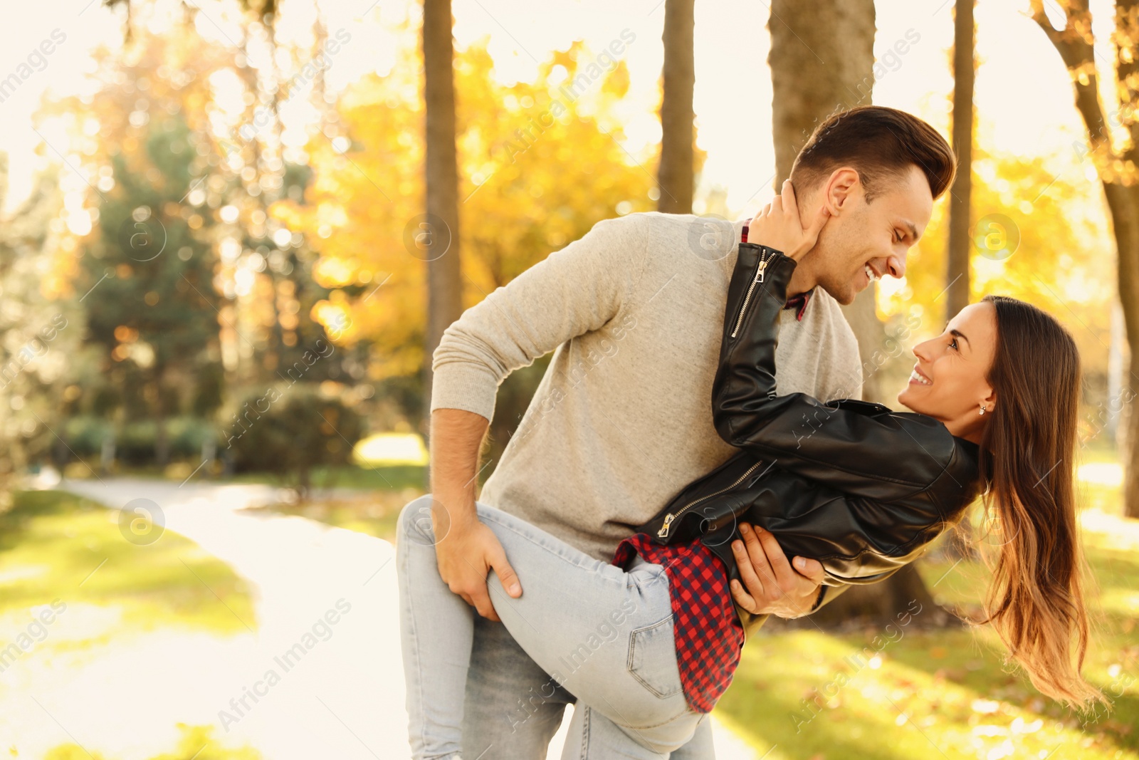 Photo of Happy couple in sunny park. Autumn walk